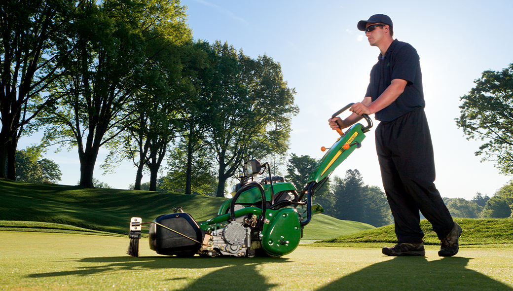 A golf course attendant using the 180 E-Cut™ Hybrid