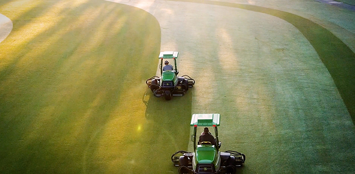Two mowers on a field